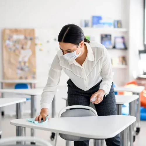 Disinfecting a classroom desk