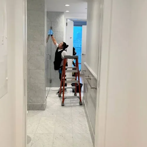 Janitor cleaning high surfaces