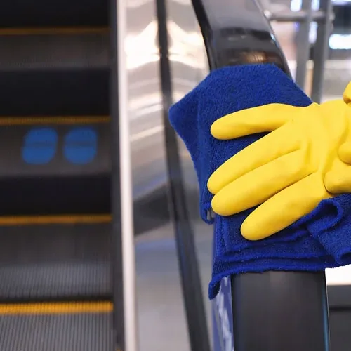 Wiping a handrail in a shopping center